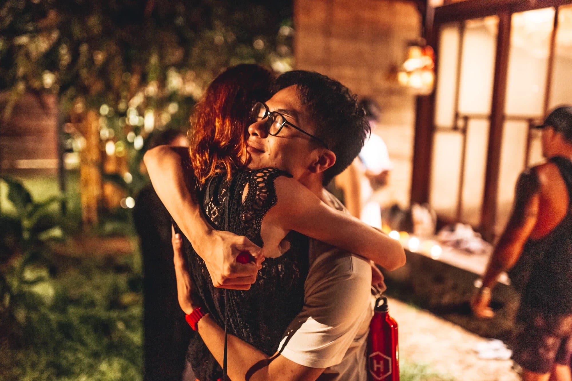 Two people in a warm embrace at a Unity Space gathering