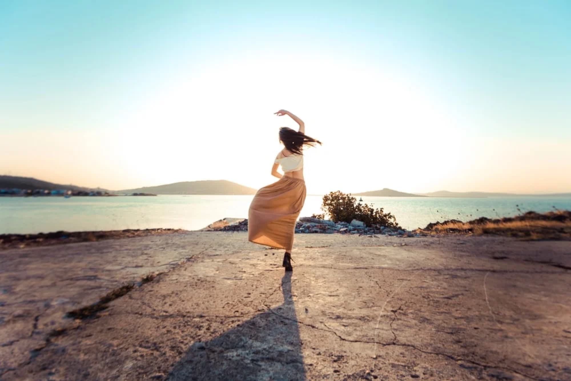 A dancer moving at sunset by the sea
